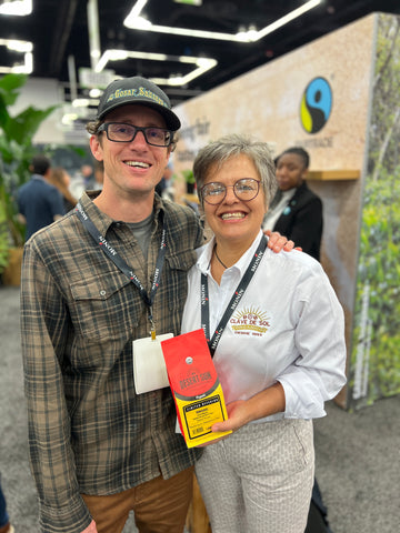 Our head roaster Brian standing with one of our farmers Betty holding a bag of Desert Sun Coffee