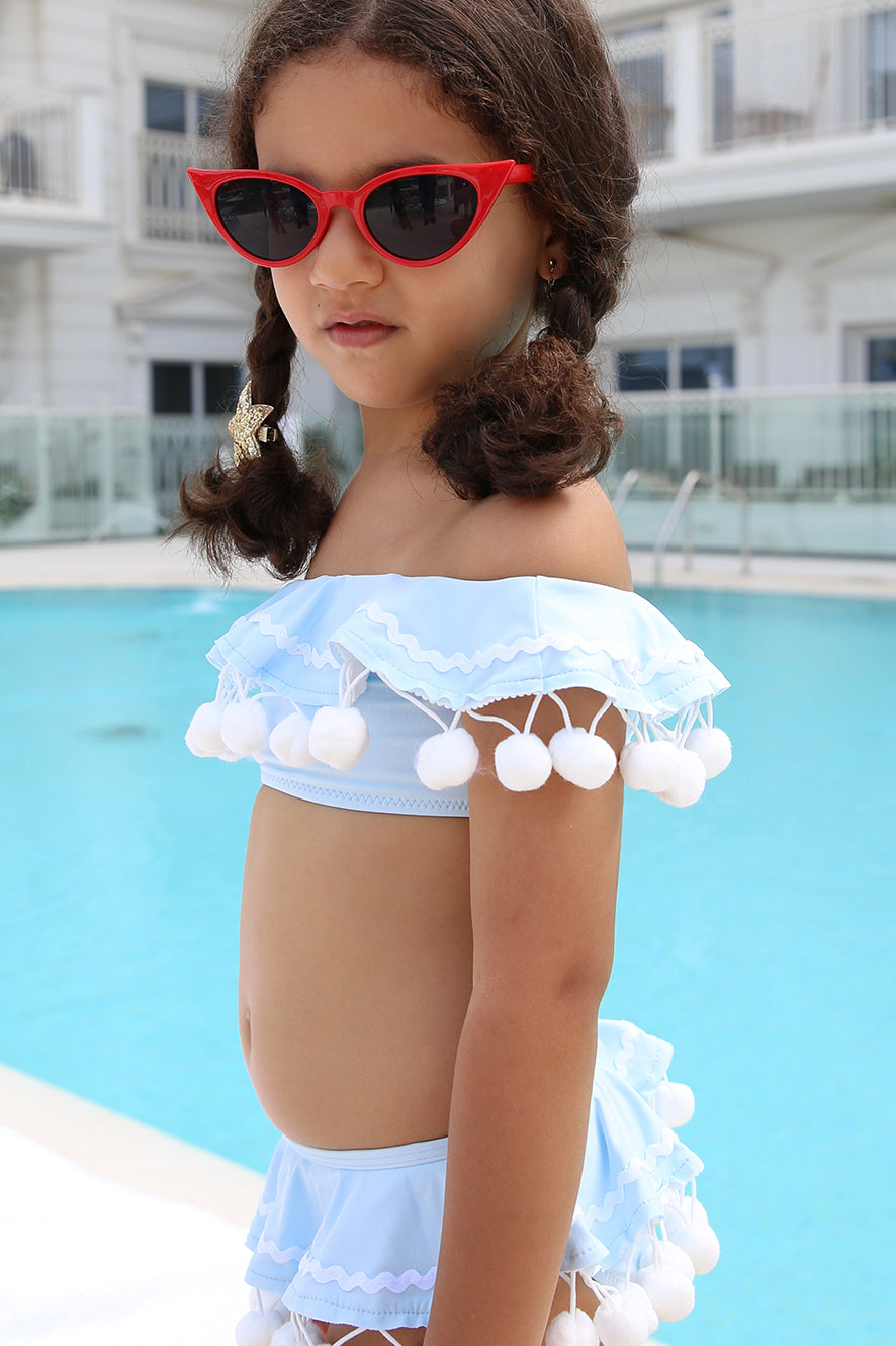 blue skirt with pom poms