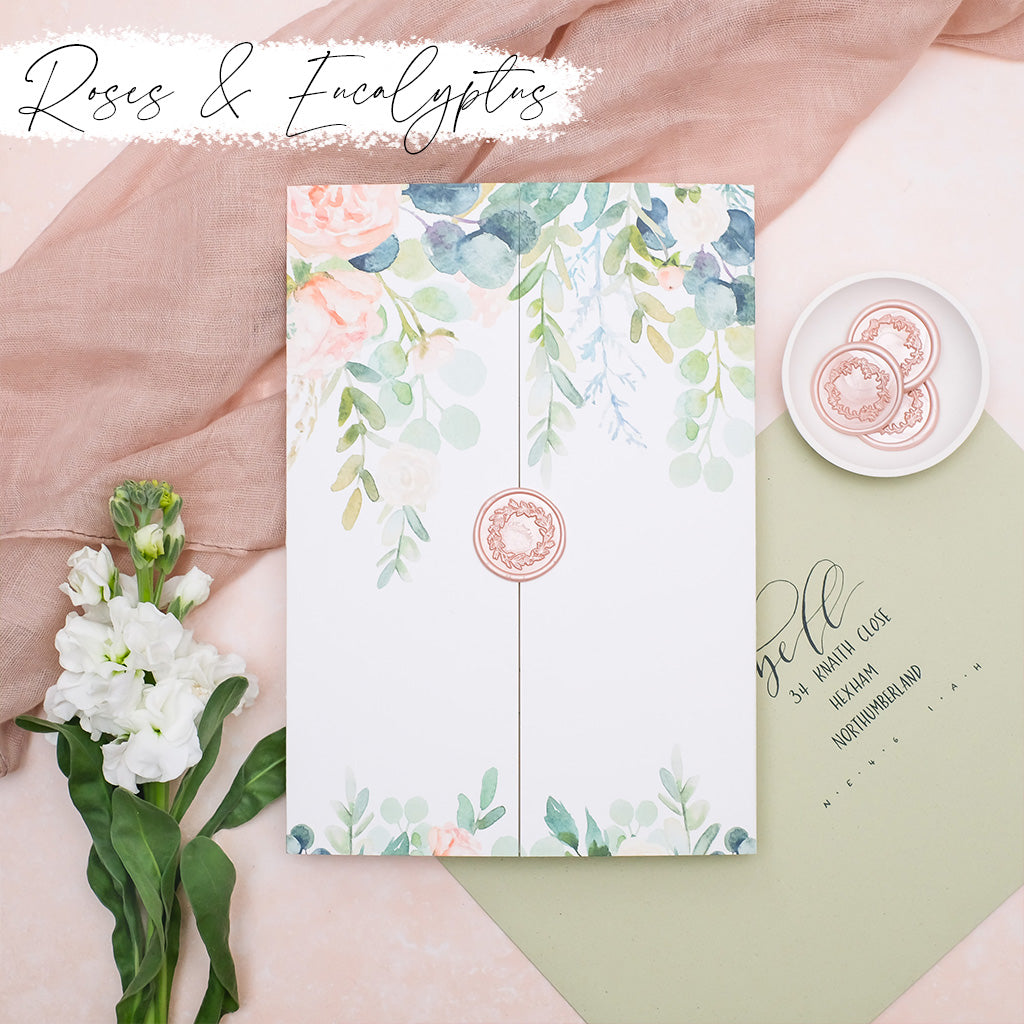 custom folded wedding invitations with roses and eucalyptus
