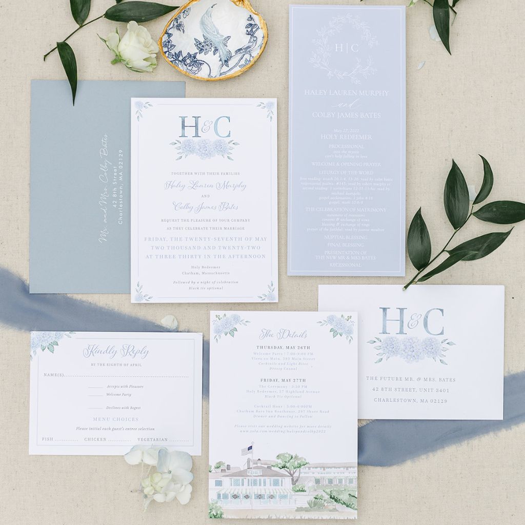 A dusty blue coastal wedding invitation suite