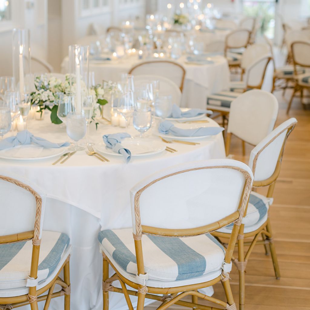 A photograph of dusty blue themed wedding table decor