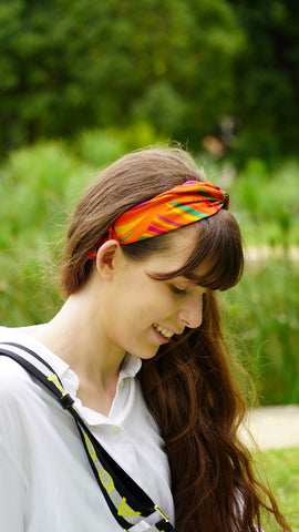 Girl wears orange silk headband