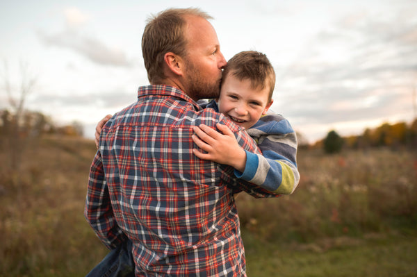 father kissing son