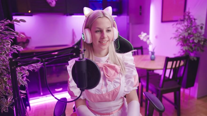 An egirl wearing a maid uniform and cat ear headphones