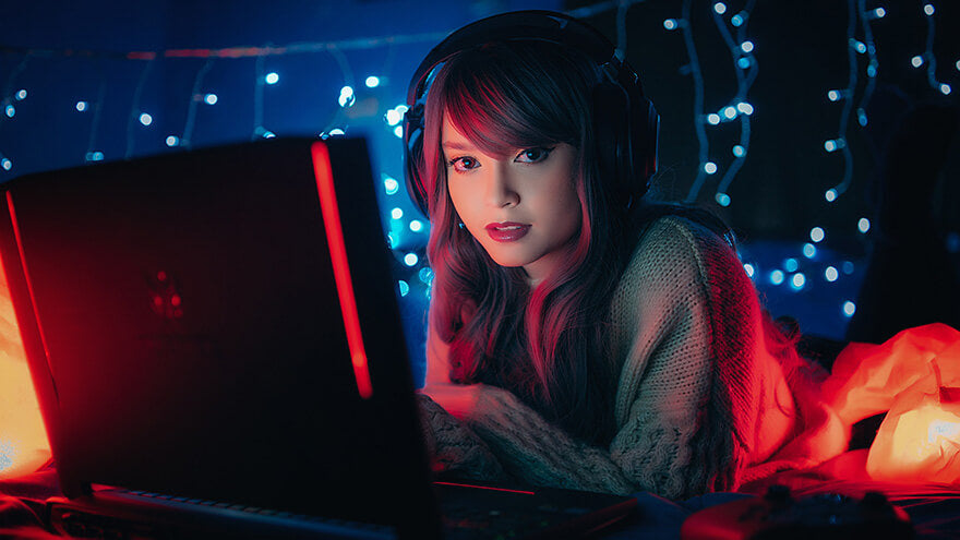 A girl playing video games in a room full of led lights