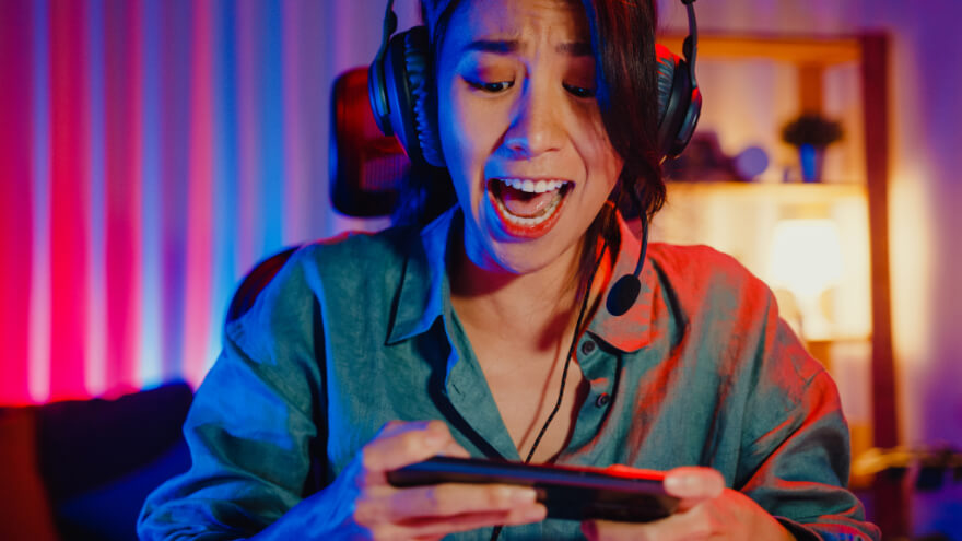 A girl playing a game with her well-covered phone