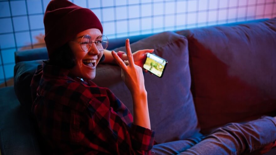 Girl playing a casual game on smartphone