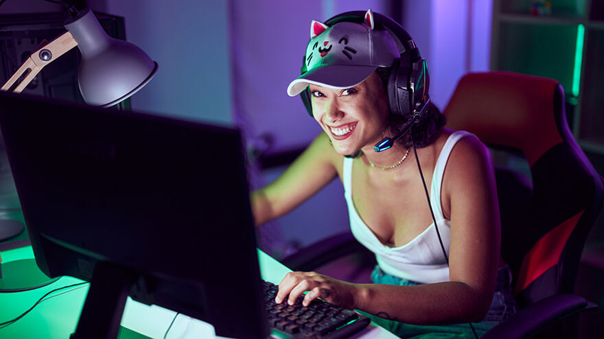 An happy gamer girl on her PC