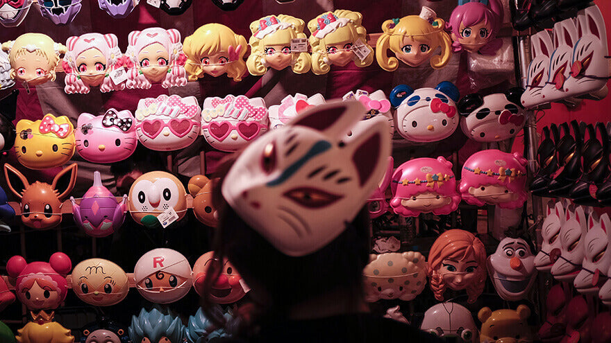 An otaku room full of anime and game characters masks
