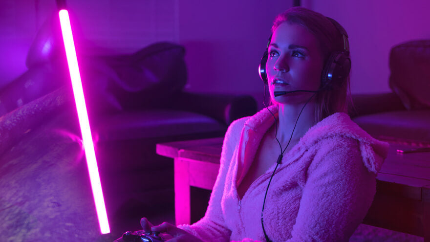 A women playing online games with her gaming headset