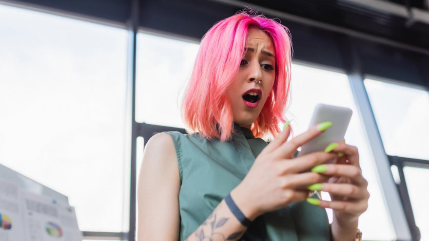 A suprised girl on a phone equipped with a silicone case