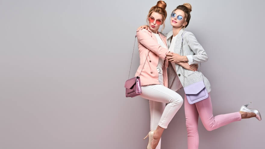 A women duo with matching color purses