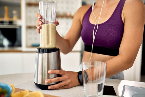 woman mixing meal replacement shake in blender