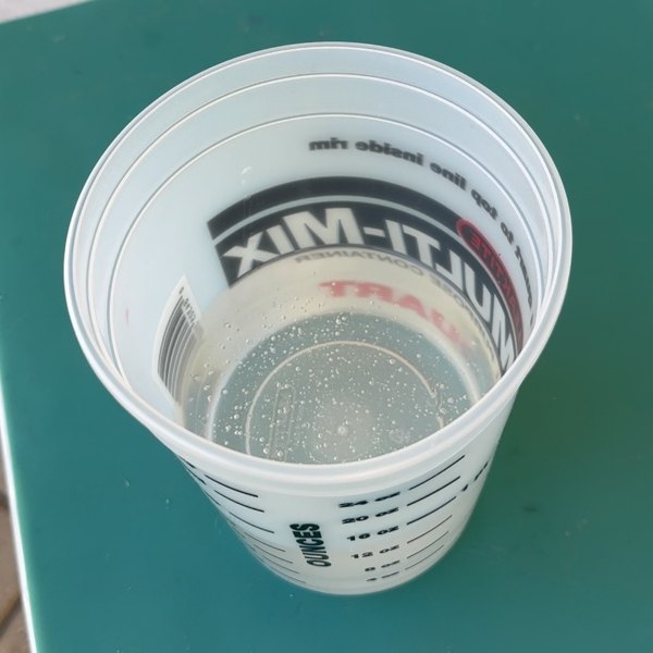 A partially filled resin mixing container.