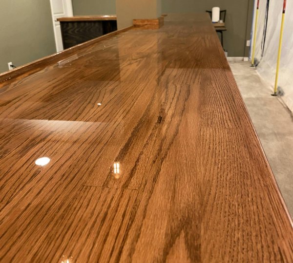 A wooden epoxy bar top, seen up close.