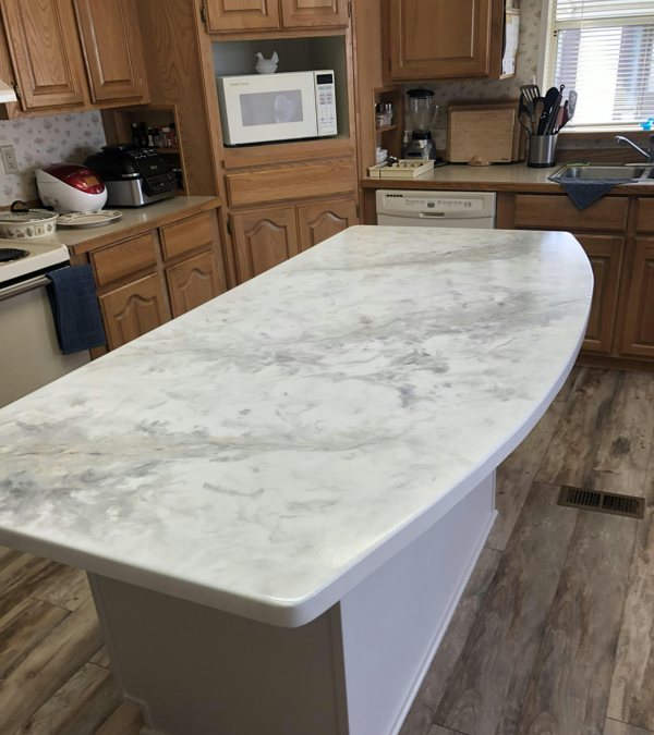 An epoxy countertop with a simulated marble finish made using epoxy pigments.