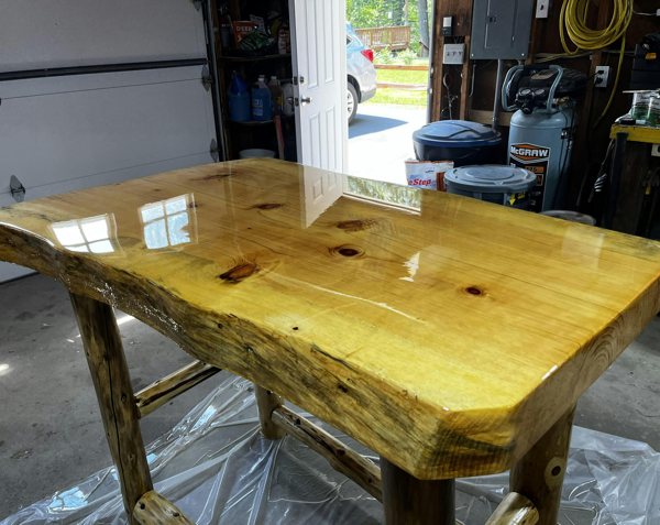 A very thick live-edge wooden epoxy table top.