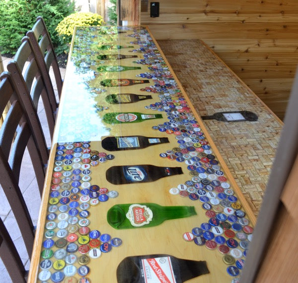 An epoxy bottle cap bar top with beverage imagery