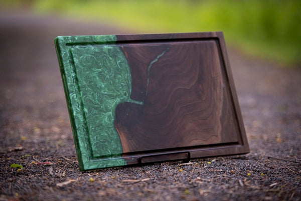 An epoxy charcuterie board with deep "algae" green hue