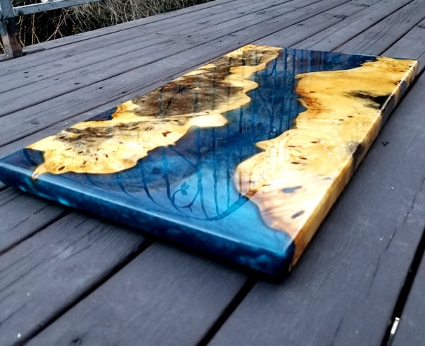 An in-progress epoxy charcuterie board, showcasing the potential color complements of wood and tinted epoxy