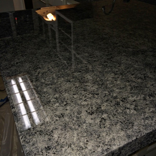 An epoxy countertop in a dimly lit room.