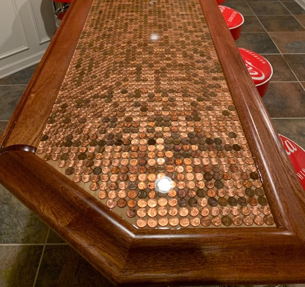 An epoxy penny bar top containing pennies with patinas
