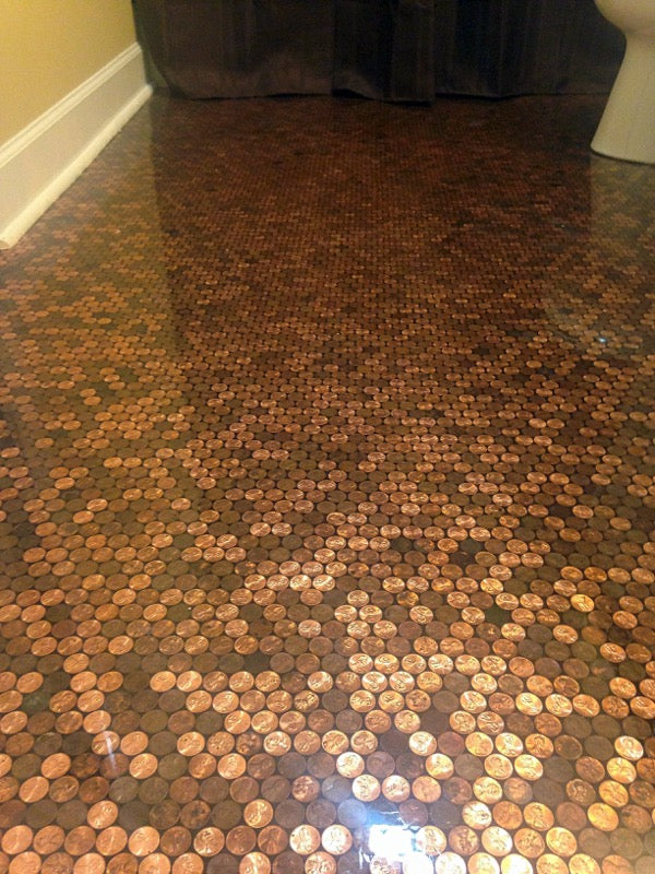 An epoxy penny bathroom floor, viewed at an angle