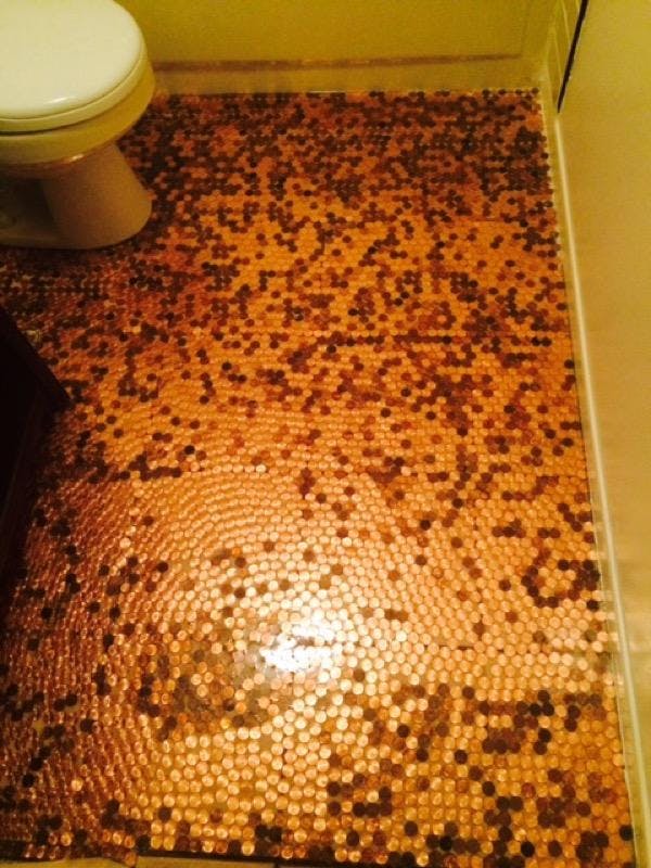 Overhead view of an epoxy penny bathroom floor