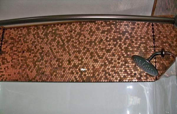 An epoxy shower wall, with embedded pennies at the top