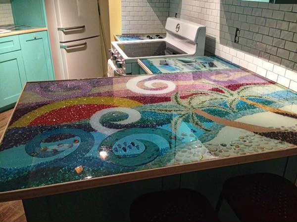 An epoxy countertop with embedded layers of colored sand patterns.