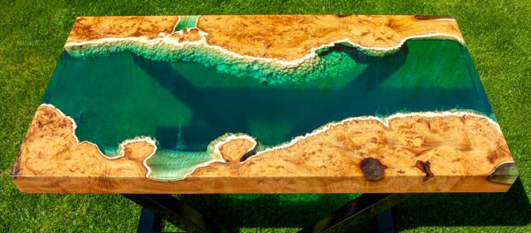 An epoxy river table with multiple deep pour coat layers