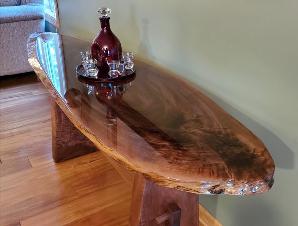 An epoxy side table top with a live edge