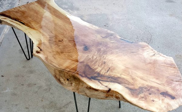 A wooden live edge epoxy table top