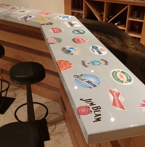 A gray epoxy bar top with embedded stickers