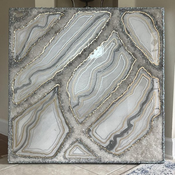 A very large piece of epoxy abstract epoxy resin art, resting against a wall.