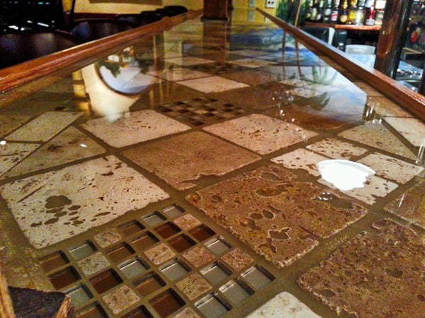 A close-up of a tile bar top with a waterproof UltraClear Bar Top Epoxy finish..
