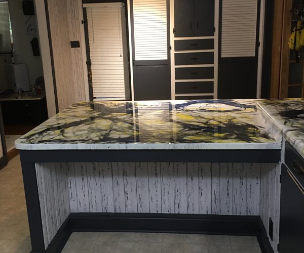 An epoxy countertop in a dimly-lit room.