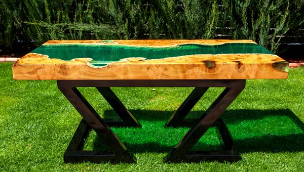 A large river table with a deep green epoxy vein.