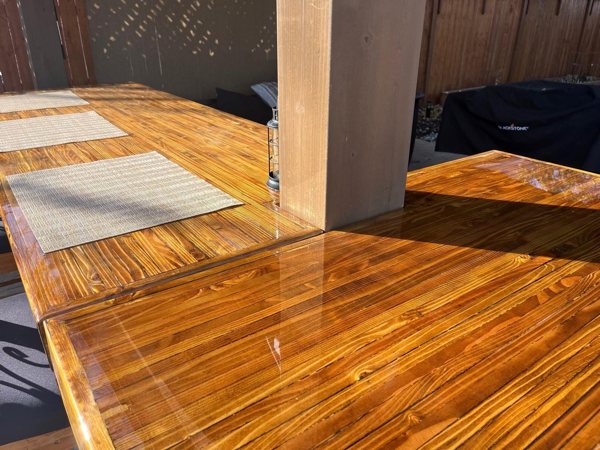 A fully cured epoxy resin finish on a wooden bar top substrate. The bar top has been installed for outdoor use.