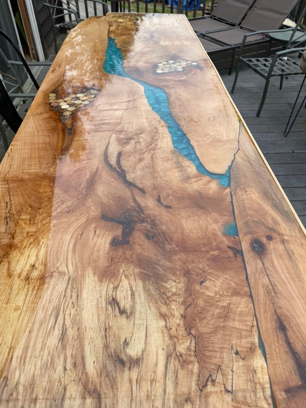 An outdoor epoxy bar top with light blue veins