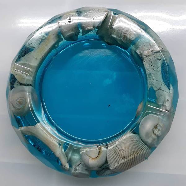 An epoxy resin art piece in the form of a ship porthole.