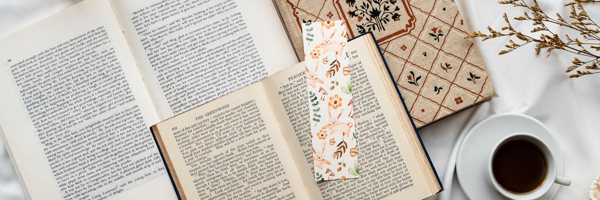 A resin bookmark resting on a stack of books.