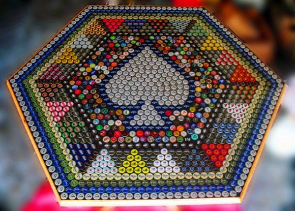 An epoxy bottle cap bar top with a spade playing card pattern