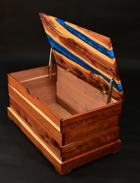 A wooden chest with deep pour epoxy veins