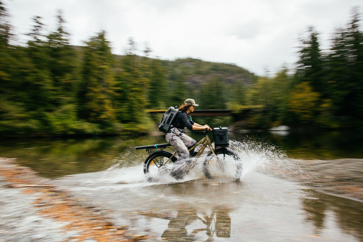 Rider crossing stream with Boar Hunter eBike by Surface 604