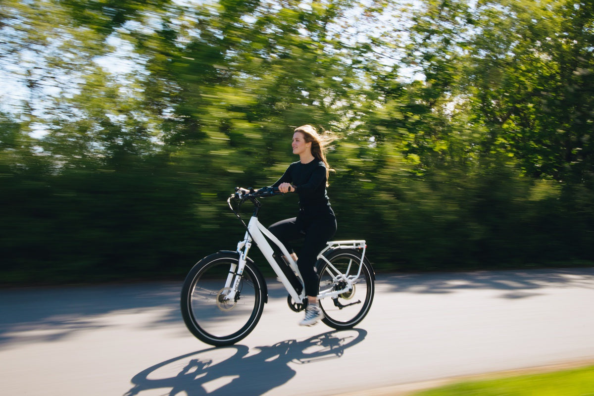 Woman riding Rook Commuter eBike at speed down road