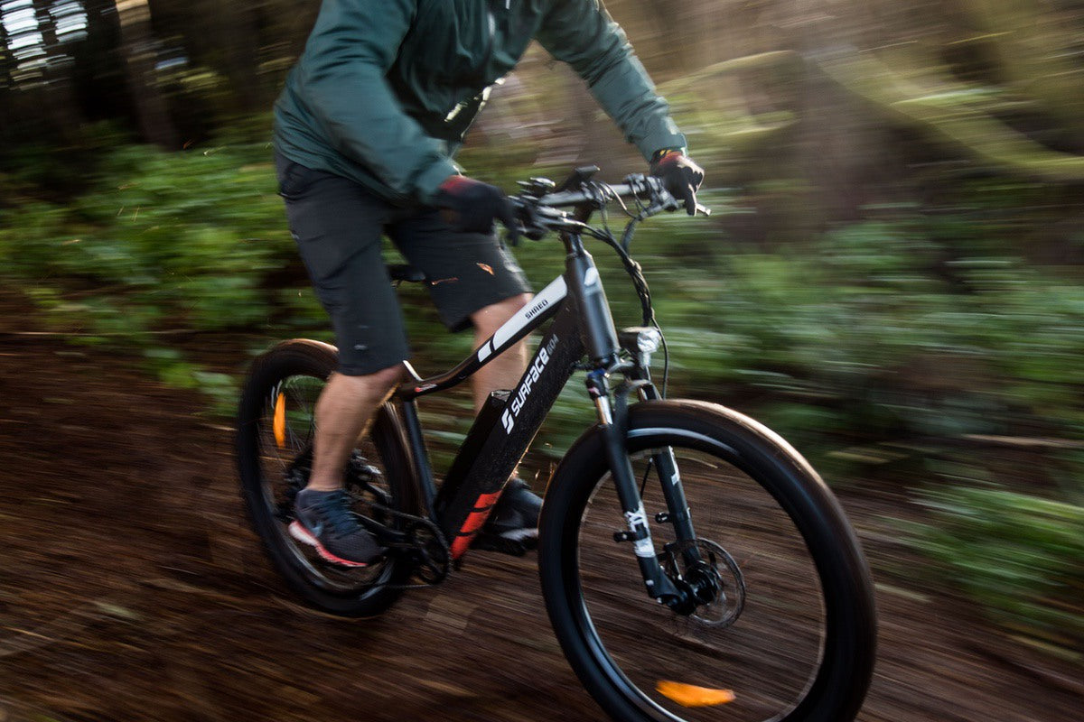 Man riding Shred eMTB through forest