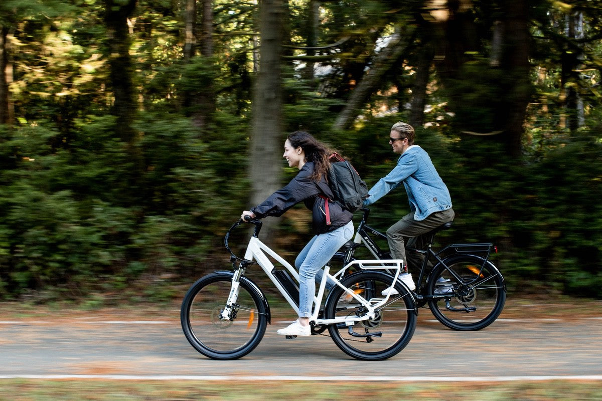 Couple riding Rook and Colt Surface604 eBikes along road
