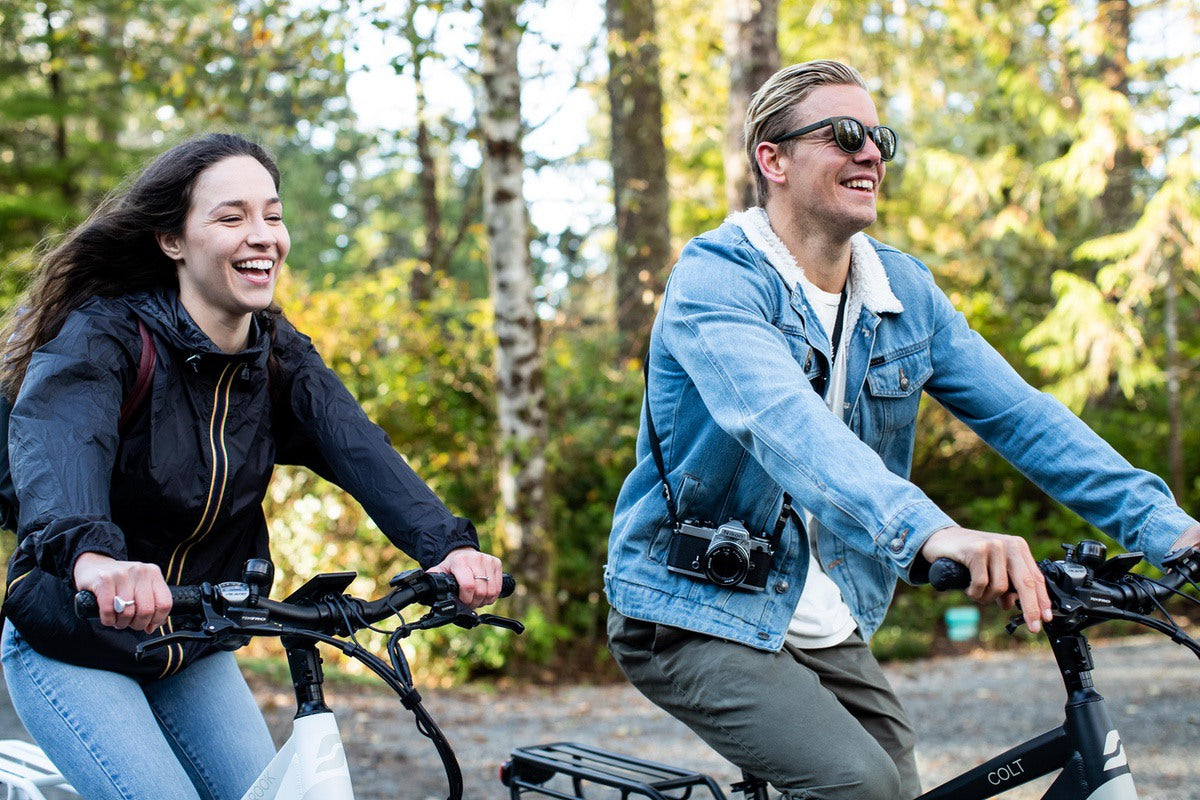 Smiling couple riding Rook and Colt commuter eBikes
