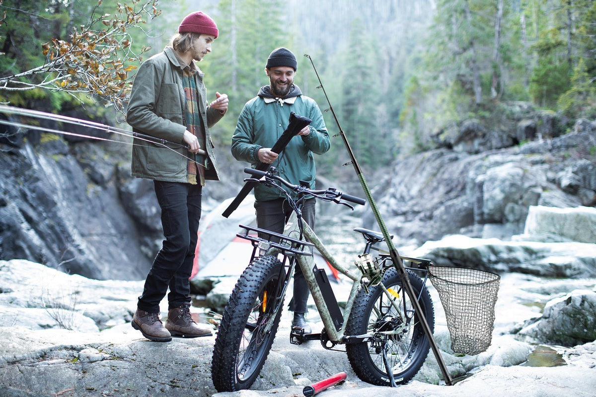 Two new riders and members of eBike group going on trip in the backcountry with Surface 604 Fat Tire eBike in foreground